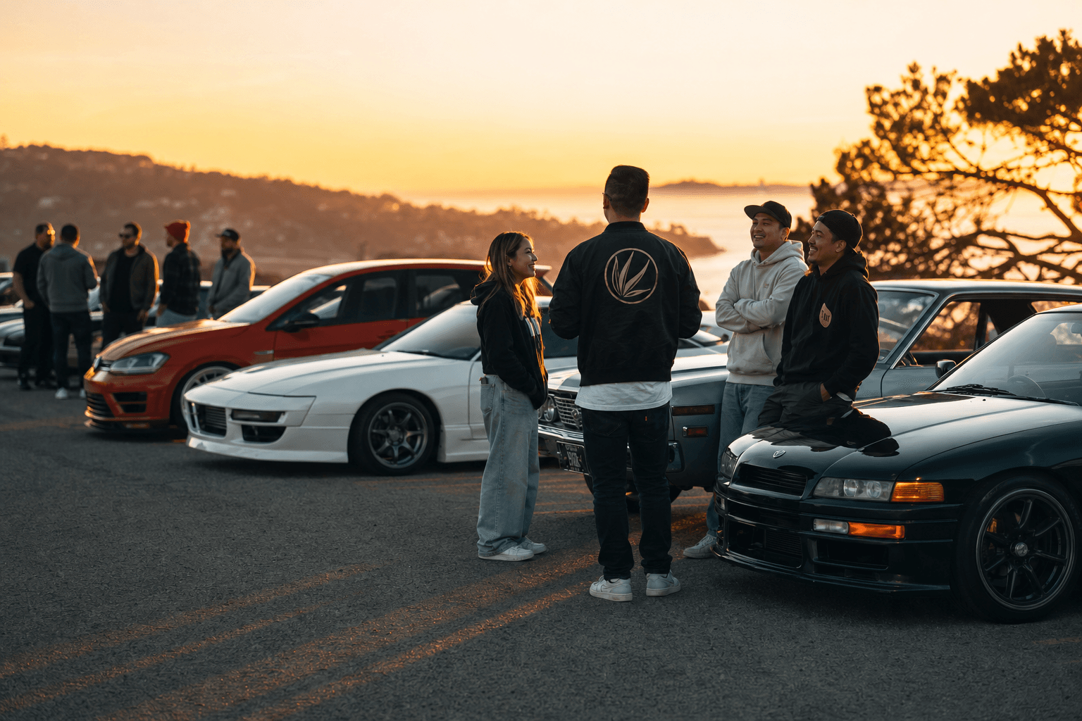 Car club crew gathered at a golden-hour meet beside a lineup of member cars